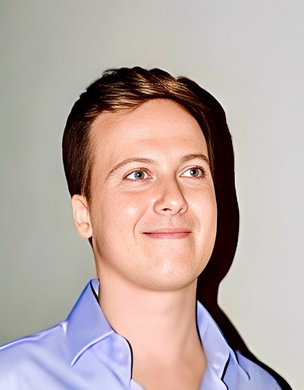 Matteo Gori, a young man with short brown hair, looks away from the camera. He's wearing a blue collared shirt.